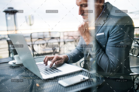 demo-attachment-33-Mature-businessman-with-laptop-outside-a-cafe.